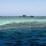 a boat floating on top of a large body of water