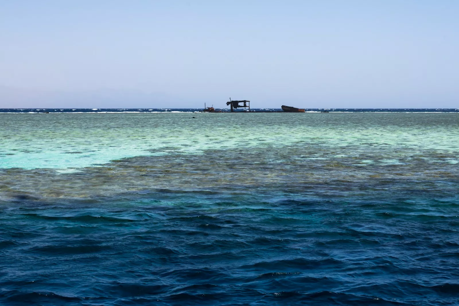 a boat floating on top of a large body of water